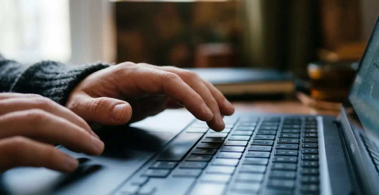 Close-up view of hands using forensic tools to analyze video file properties and encoding signatures
