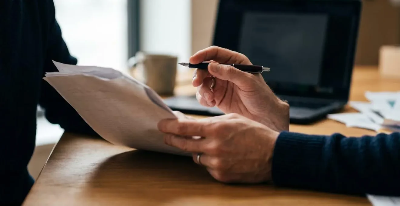 Close-up of hands reviewing and annotating AI-generated content with personal insights