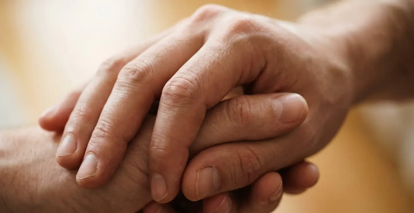 Two hands in gentle, affectionate contact captured in intimate close-up, emphasizing the tactile and emotional dimensions of human touch