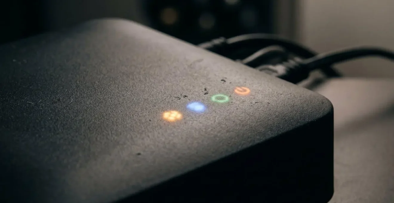 Close-up macro view of illuminated smart hub LED indicator lights showing constant standby mode energy consumption