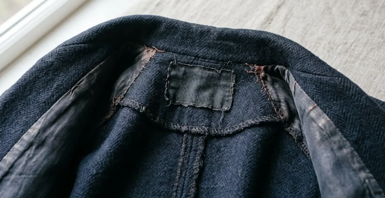 Vintage garment interior showing union tag and fabric care symbols in natural lighting